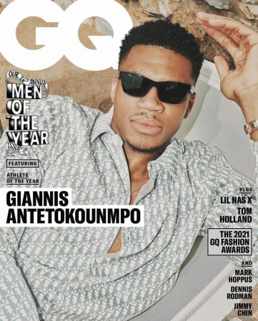 GQ magazine cover featuring Giannis Antetokounmpo in sunglasses and patterned shirt, posing outdoors with rock background and magazine text.