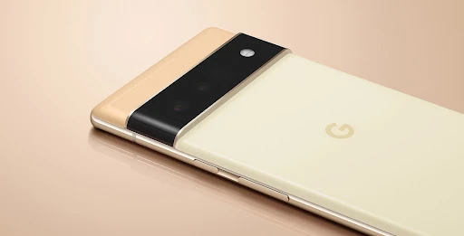 Close-up of two Google Pixel 6 phones, one in a cream color and the other in a gold color, highlighting their camera setup.