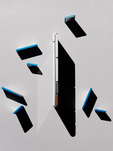 Modern smartphone displayed vertically with shadow and scattered covers on a light grey background creating a technology product still life.