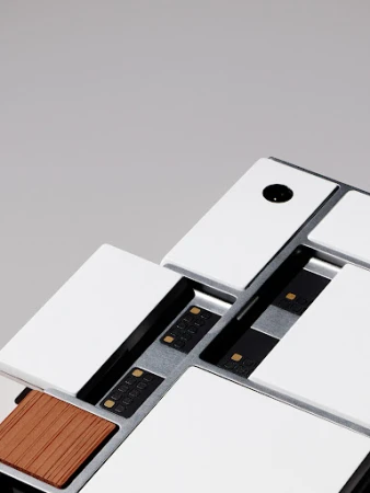 Modern modular control device featuring a white, silver, and wood color palette set against a neutral gray backdrop.