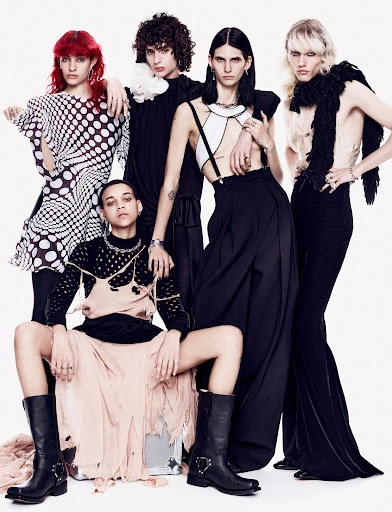 Group of five fashion models posing together against a plain white background by photographer Billy Kidd.