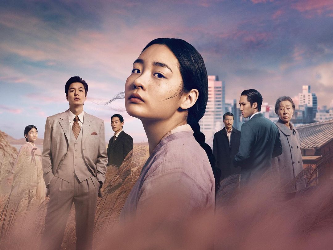 Portrait of an Asian woman with a group of people in suits in the background, cityscape, and field with dried grass.