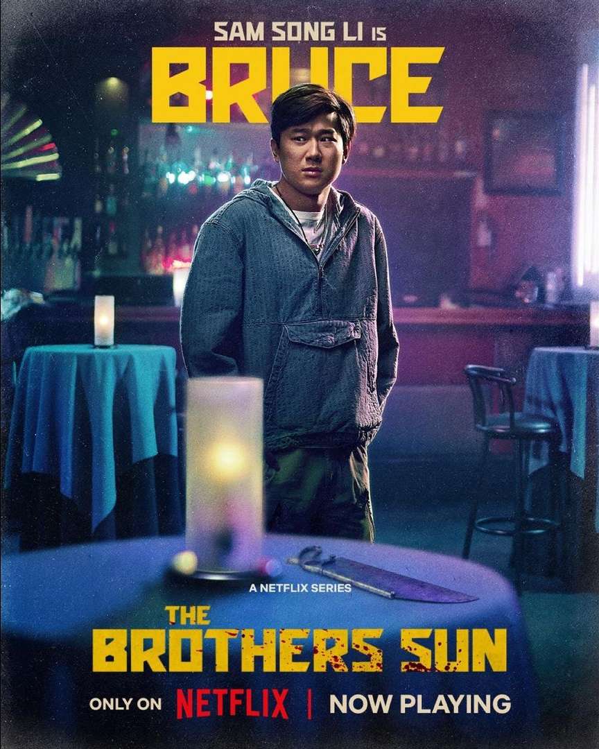 Promotional image for The Brothers Sun on Netflix features actor Sam Song Li as Bruce, set in a bar with ambient lighting.