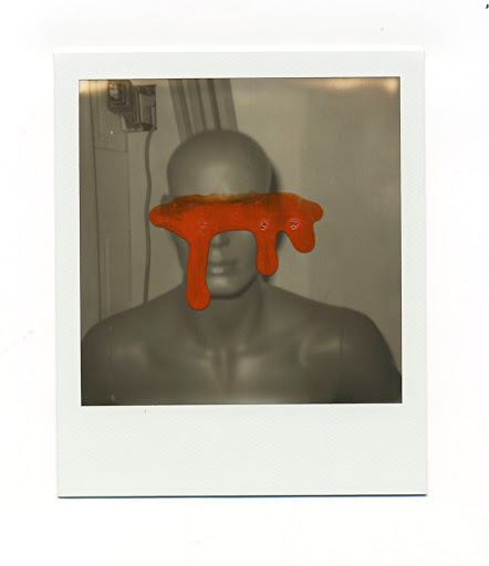 Grayscale photograph of a mannequin bust in a white frame with an orange drip obscuring the eyes, artistic, abstract, studio.
