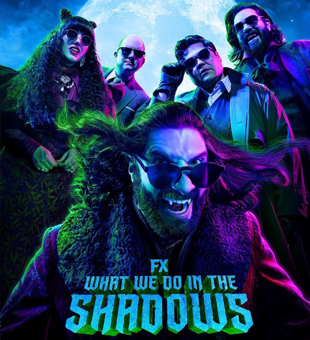 Promotional image for What We Do in the Shadows featuring five people with dark sunglasses and a large moon behind them.