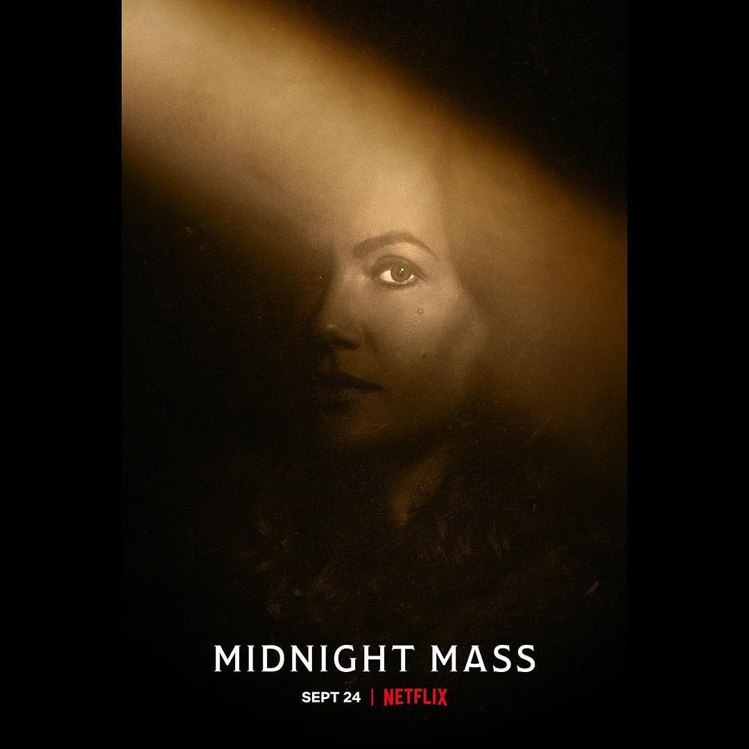Movie poster of a woman's face in a beam of light against a dark background for 'Midnight Mass' movie on Netflix, Sept 24th.