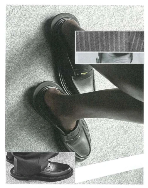 Elevated view of a man's lower legs and feet wearing leather loafers, set against a speckled grey floor with collage elements.