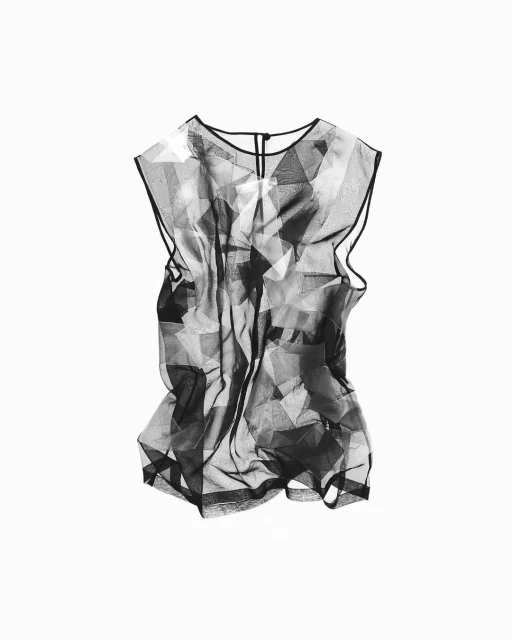 Black and white sheer sleeveless top with geometric pattern isolated against white backdrop in a fashion studio shot for product display.