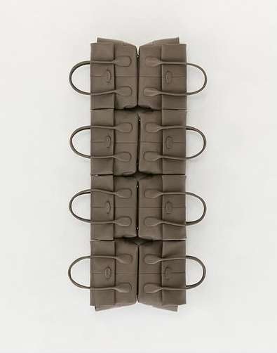 Eight grey leather handbags arranged symmetrically in two vertical columns against a white background