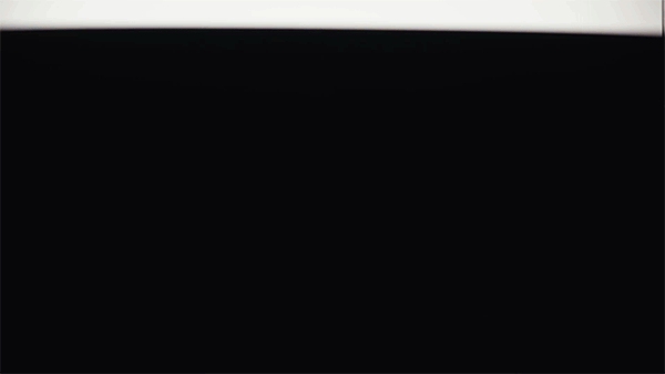 Dark abstract background featuring a black surface with a bright white line accentuating the upper edge, minimal in composition.