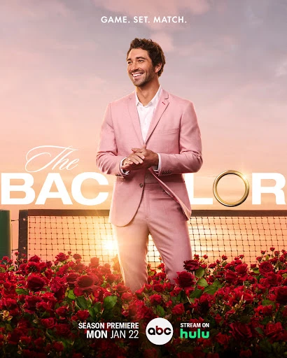 A promotional shot of a smiling man in a pink suit for 'The Bachelor' TV show, set against a warm sunset and a tennis court backdrop.