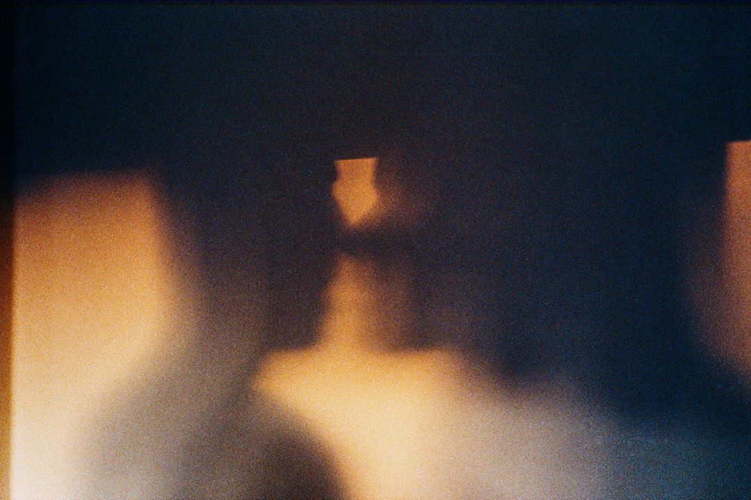 Abstract composition featuring blurred lights and dark shadows, creating an ethereal, dreamlike, and atmospheric visual experience.