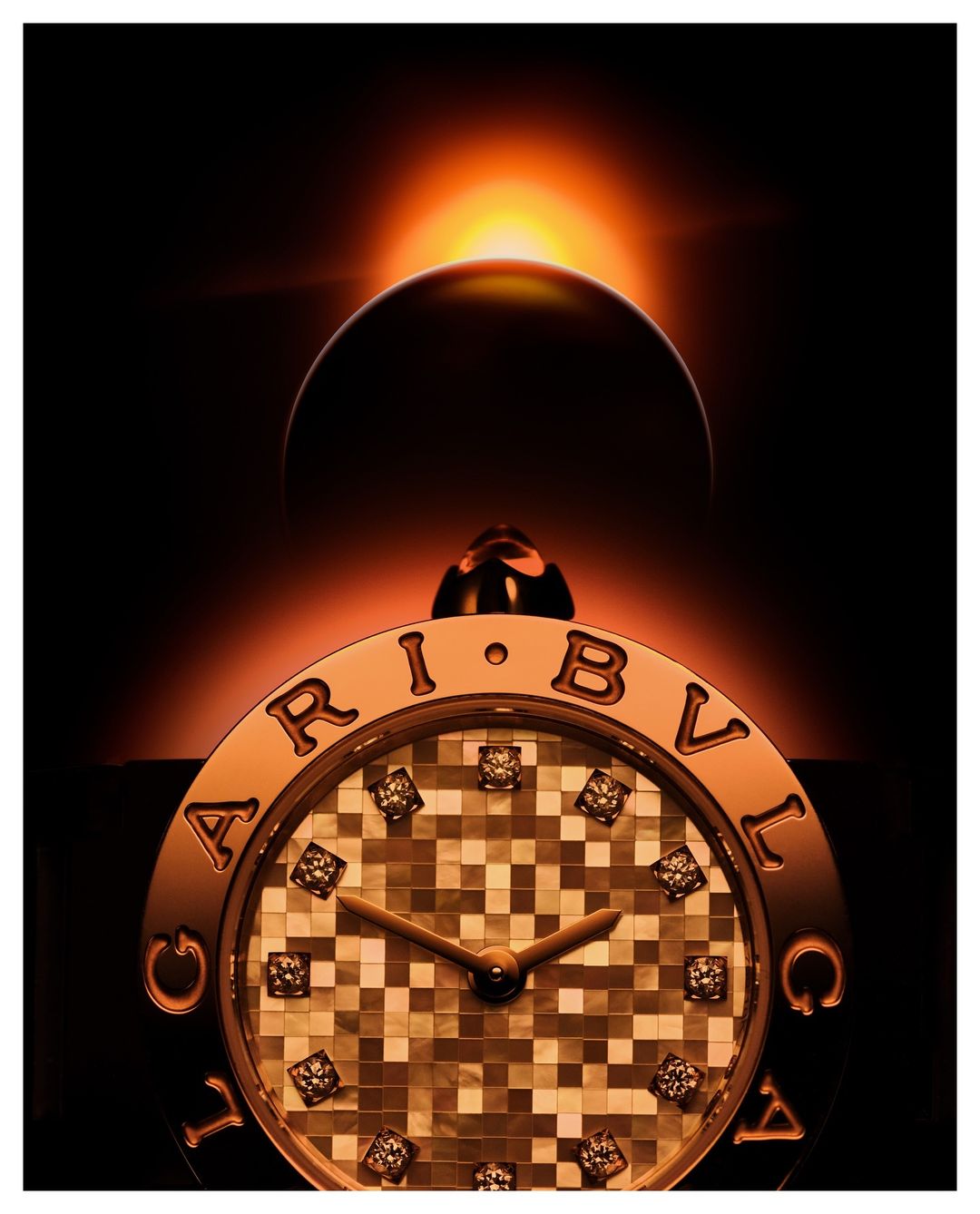 Luxury BVLGARI watch with diamonds against a dark background and a solar eclipse in the sky, showcasing precision and elegance.