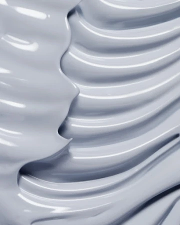 Abstract close-up of a thick grey cream with shiny texture, showing a wavy pattern and smooth surface, perfect for beauty product.