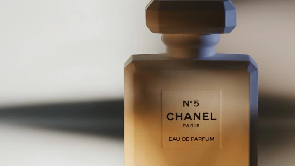 Chanel No. 5 perfume bottle on a neutral background, featuring the iconic label, clean lines, and a play of light and shadow.
