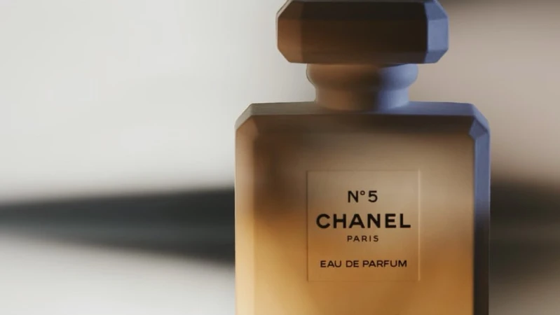 Chanel No. 5 perfume bottle on a neutral background, featuring the iconic label, clean lines, and a play of light and shadow.