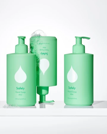 Three light green pump bottles of hand soap with white teardrop logos arranged on a white surface against a white backdrop.