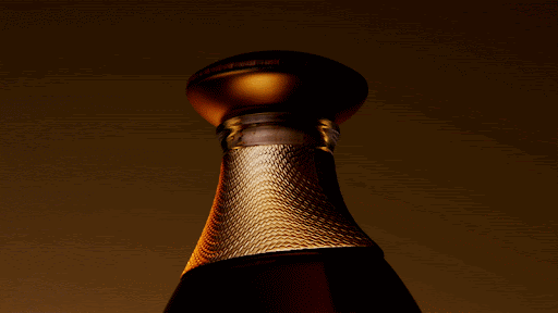 Elegant perfume bottle close-up featuring a golden cap and textured surface, set against a warm, muted brown background with soft lighting.