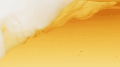 Foamy beer in glass close-up, golden hue, offering a refreshing visual and a sense of indulgence. Ideal for food and beverage themes.