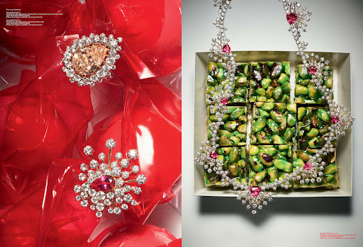 High-fashion shot showcasing diamond jewelry adorned with gemstones, set against red balloons and green pistachio candy in a square box.