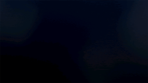 Dark, almost black image with subtle, shifting gradients of blues and greys providing a textured and visually interesting backdrop.