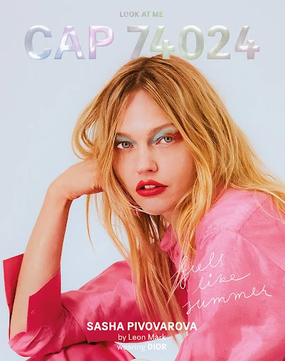Portrait of Sasha Pivovarova wearing pink top and red lipstick, against a light blue backdrop, as seen on the cover of CAP 74024.