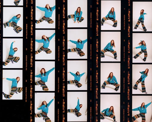 Young woman in a blue sweatshirt and colorful striped pants poses dynamically in multiple frames of film strip against a white background.