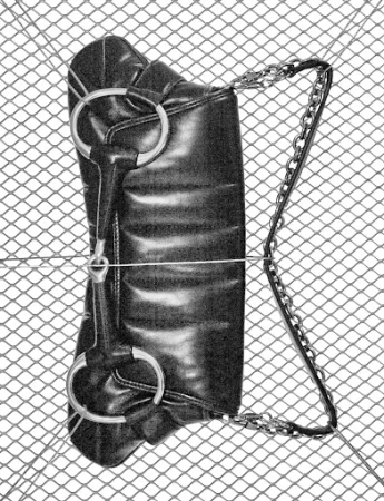 Elevated shot of a black faux-leather handbag with silver chain handle, resting on a diamond-patterned wire mesh.
