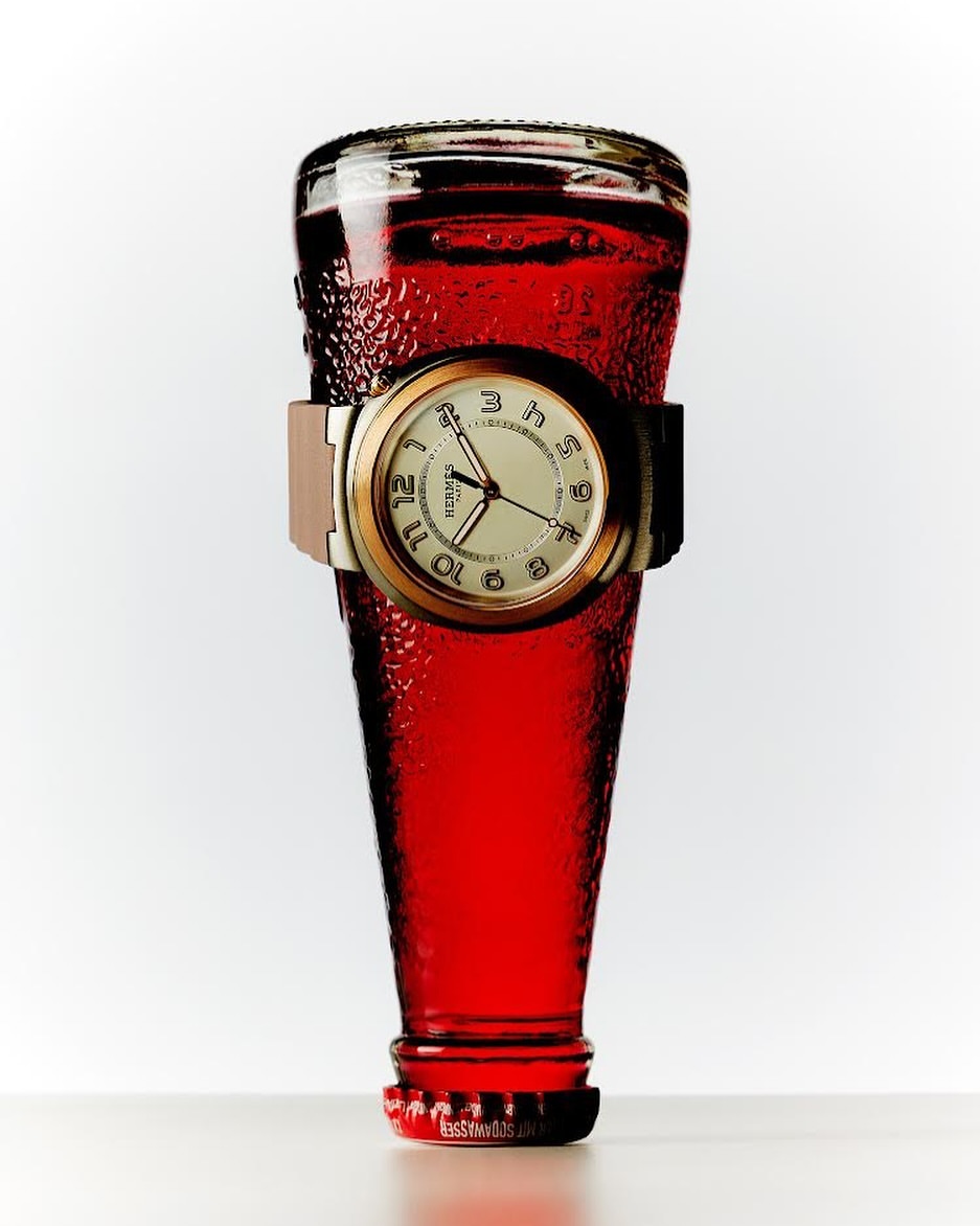 Still life studio shot of a red liquid-filled glass bottle featuring a wristwatch around its center, against a bright white background.