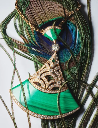 Elegant gold necklace with malachite and diamond pendant on a peacock feather background, studio lighting, jewelry still life.