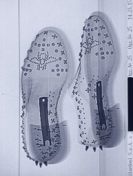 X-ray scan image showing the internal structure of two studded shoes with visible metal shanks and hardware.