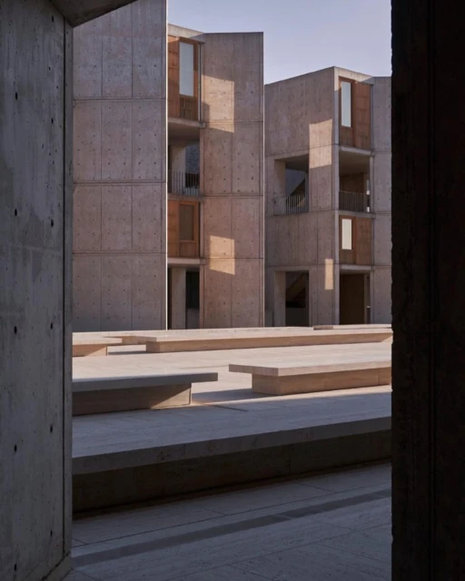 Exterior architecture featuring concrete modernist buildings with windows and geometric shapes, showcasing architectural design and form.