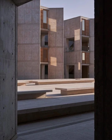 Exterior architecture featuring concrete modernist buildings with windows and geometric shapes, showcasing architectural design and form.