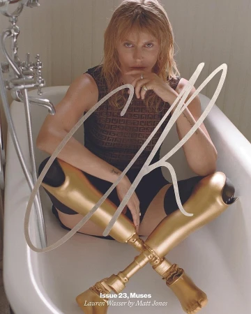 Blond woman sits in a tub with gold prosthetic legs crossed. Editorial image from Issue 23 of Muses Magazine by Matt Jones.