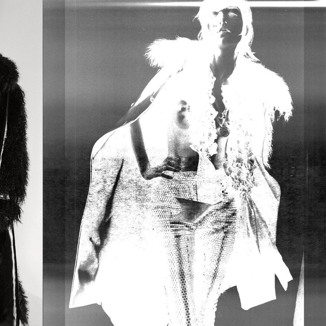 Monochrome fashion shot of a woman in an ornate dress with fur trim and a second woman in a fur coat standing against a gradient background.