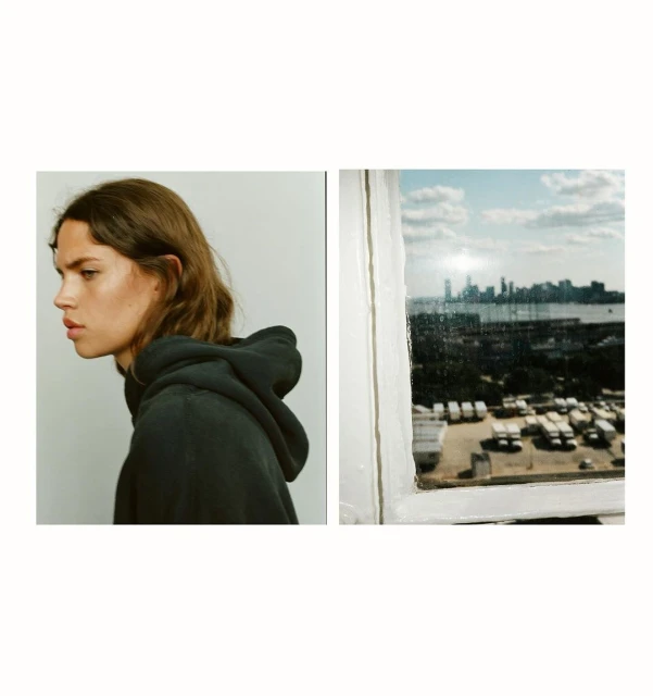 Split-frame portrait of a young woman in a hooded sweatshirt juxtaposed with a cityscape view seen through a grimy window.