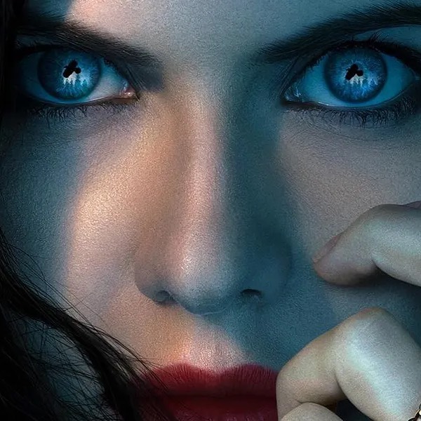 Extreme close-up of a woman's face with bright blue eyes reflecting a cityscape. Red lipstick accentuates her mouth in soft, diffused light.