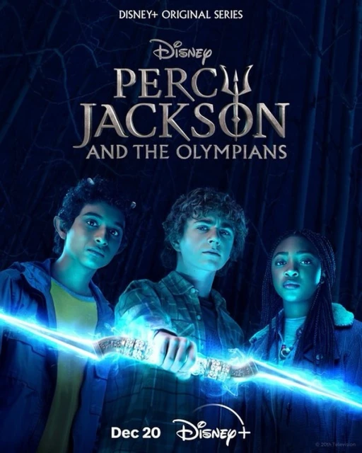 Promotional image of the Disney+ series Percy Jackson and the Olympians features three young actors holding a glowing blue object in a dark forest.