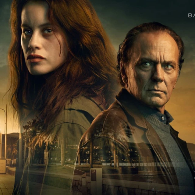 Film poster featuring a woman with long brown hair and a man in a leather jacket, with a cityscape reflected in their images.