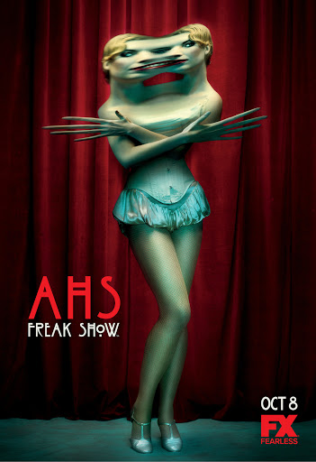 Conjoined twins Bette and Dot Tattler from FX's American Horror Story: Freak Show, standing in costume in front of a red curtain.