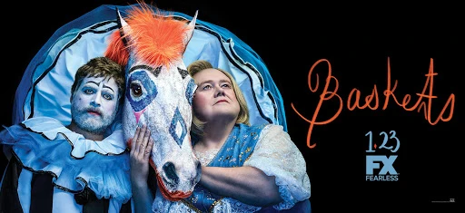 Comedy TV series promo image featuring two performers in clown makeup and costume with a decorated horse head, set against a black backdrop.