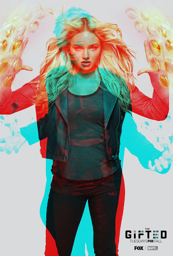 Blonde-haired woman poses in a promotional poster for the series 'The Gifted,' wearing a black jacket and leggings against a light background.