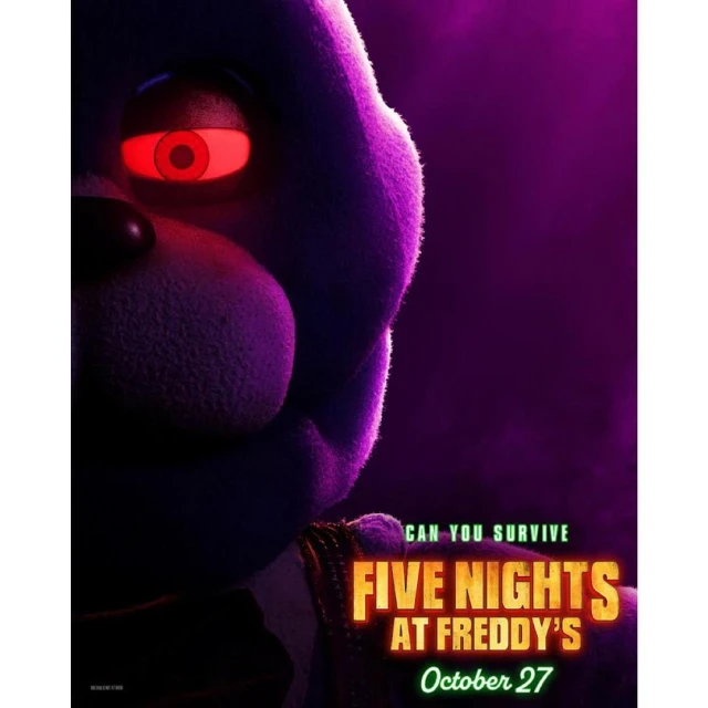 Close-up of the Five Nights at Freddy's movie poster featuring a purple animatronic bear with glowing red eyes against a purple background.