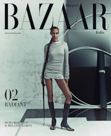 Fashion editorial magazine cover featuring a slender Black woman in a grey dress and knee-high boots posing in a photo studio.