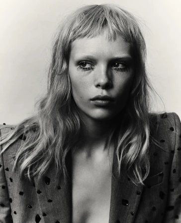 Portrait of a woman with bangs and textured jacket against a plain background by art directors Melanie and Ramon