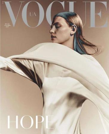 Vogue UA cover featuring a female model in a flowing white garment, set against a neutral backdrop, showcasing fashion and portrait photography.