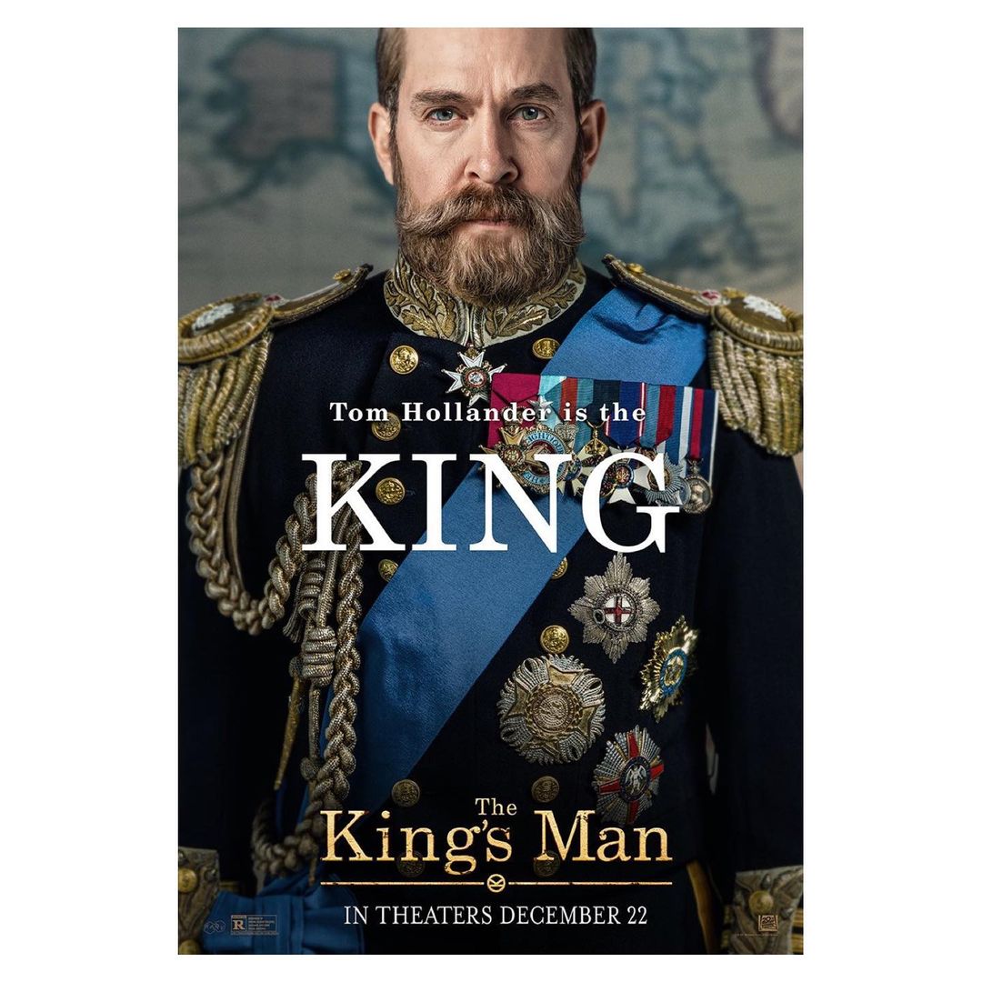 Movie poster for The King's Man featuring Tom Hollander in military attire with medals and intricate gold braiding on a map background.