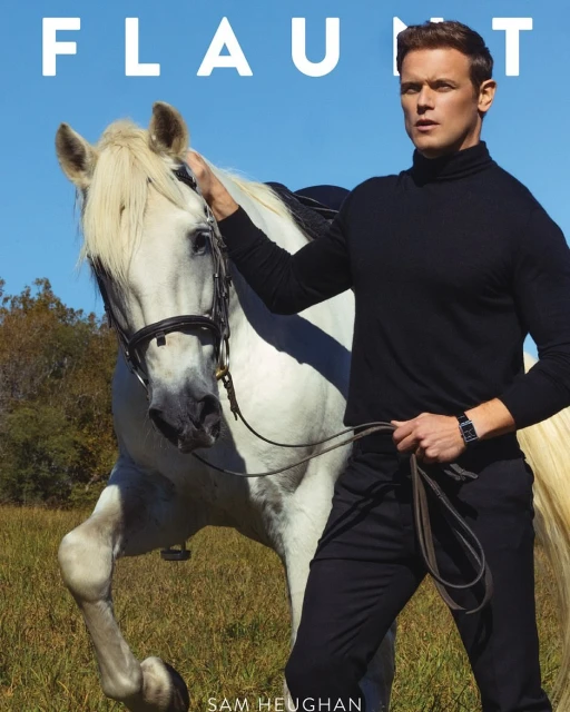 Sam Heughan poses with a white horse in a field under a blue sky, promoting Flaunt Magazine. He wears a black turtleneck and pants.