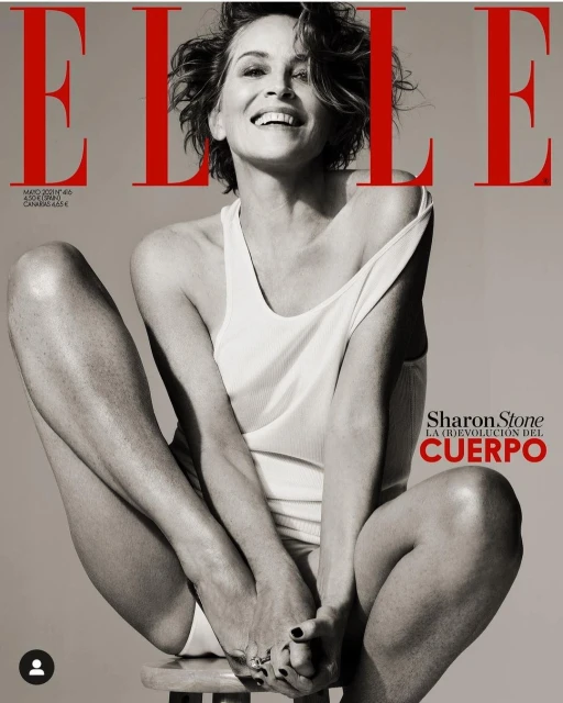 Elle Magazine cover featuring Sharon Stone sitting on a stool, wearing a white top and bottom. Black and white fashion photography.