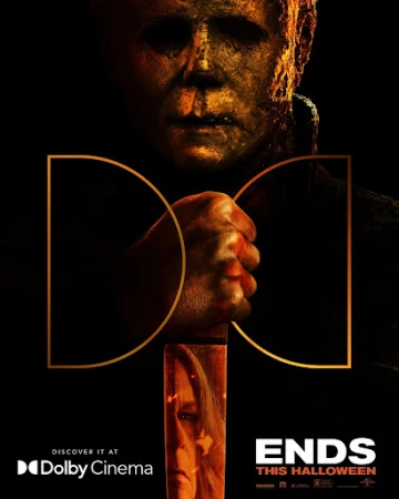 Close-up poster of Michael Myers holding a knife with a reflection of a woman's face on the blade against a dark background